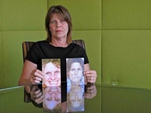 Cris Sardina of Desiree Alliance holding pictures of Marcia Powell Photo credit: PJ Starr